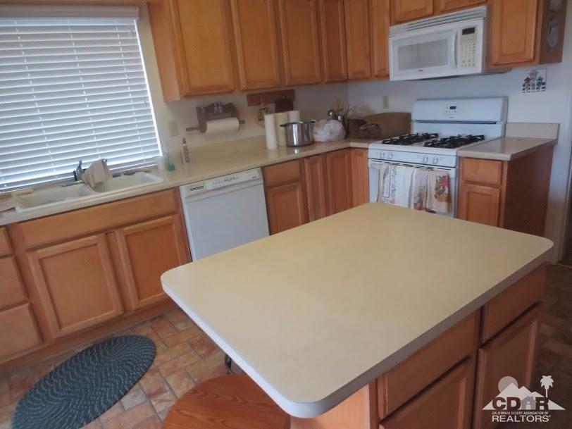 5959 Maybrook Circle Riverside, CA 92506 - Photo 6 of 18 a kitchen with stainless steel appliances a sink a stove a refrigerator cabinets and a counter top space