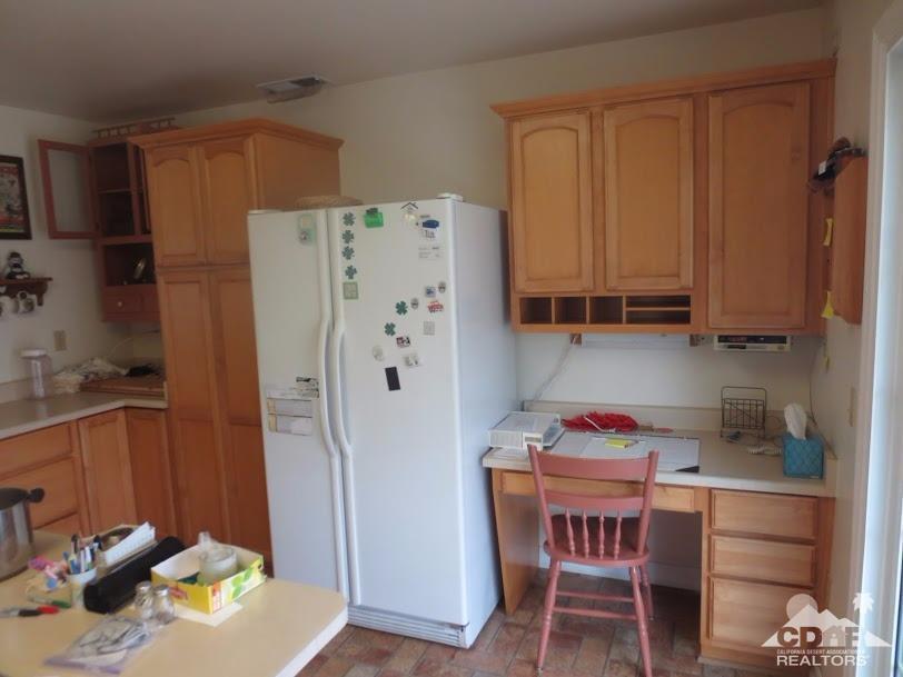 5959 Maybrook Circle Riverside, CA 92506 - Photo 8 of 18 a kitchen with a refrigerator and a stove top oven