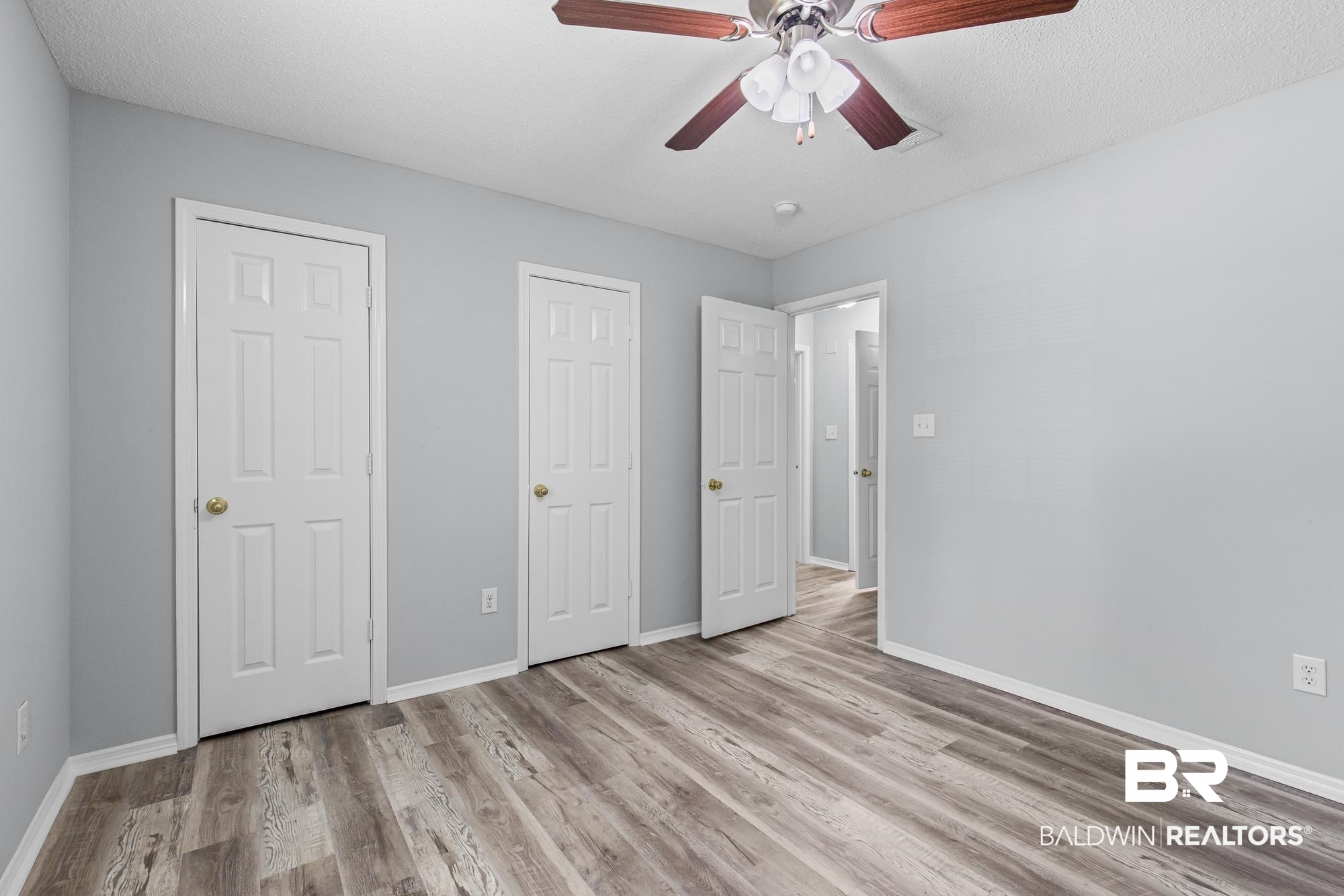 6933 Burbank Court Mobile, AL 36619 - Photo 19 of 25 Spacious room featuring wood-finish flooring and a ceiling fan with integrated lighting