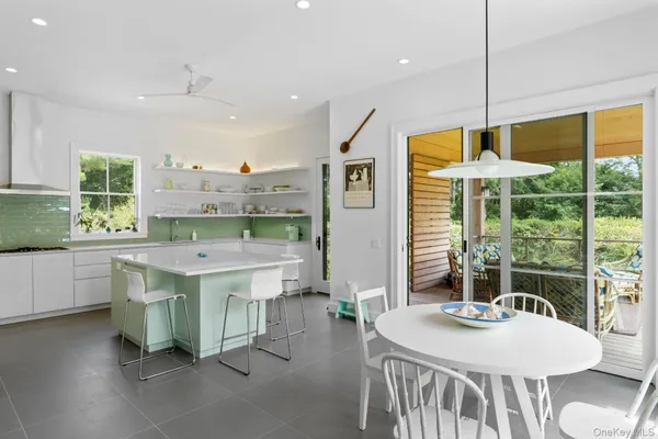 a view of a kitchen with kitchen island a large window in it