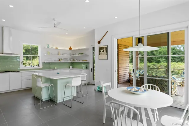 a view of a kitchen with kitchen island a large window in it