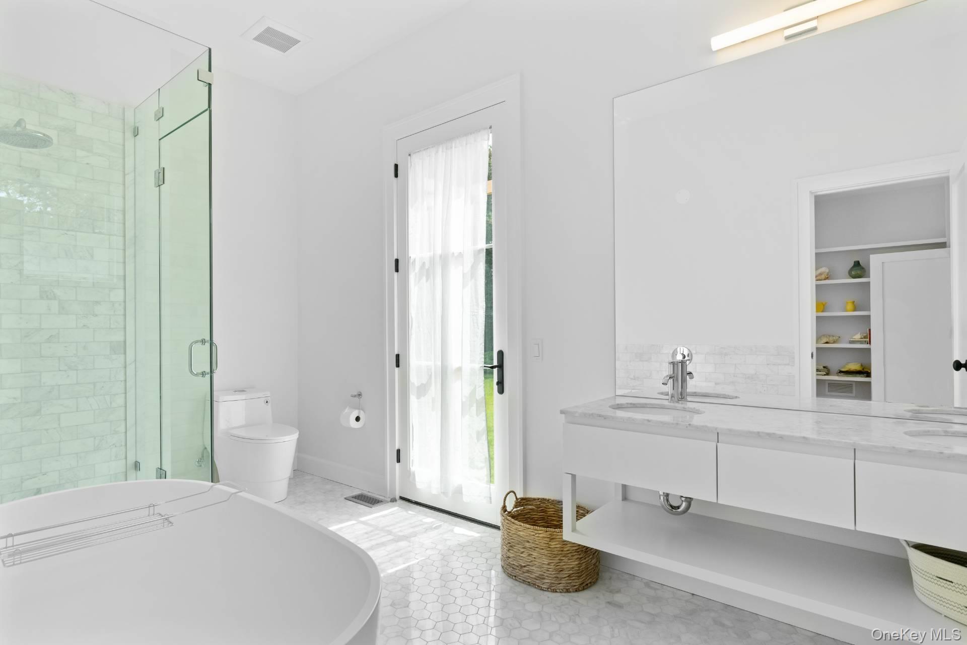 26 Georgian Lane Water Mill, NY 11976 - Photo 17 of 45 a bedroom with a bed and a chandelier