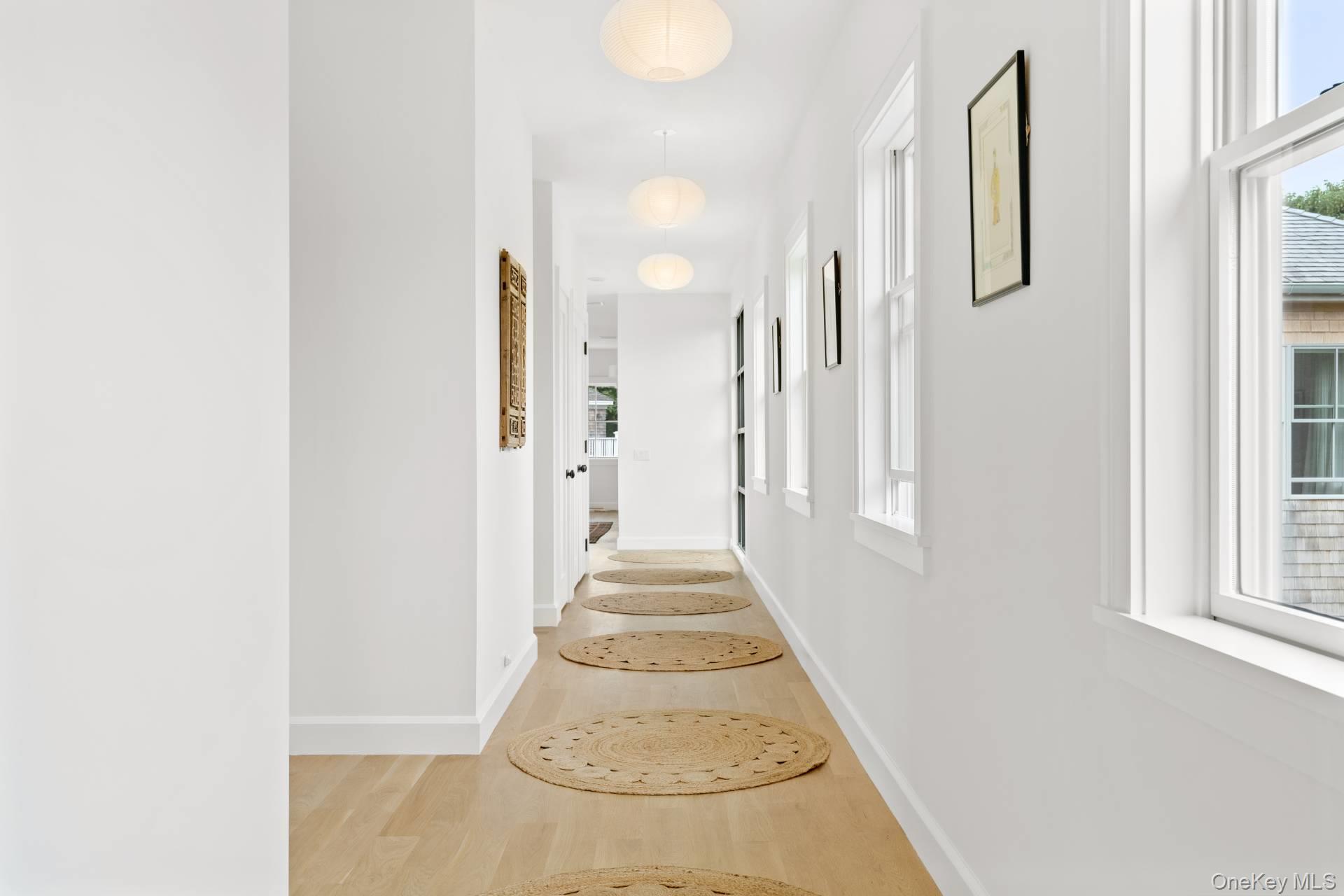 26 Georgian Lane Water Mill, NY 11976 - Photo 18 of 45 a view of a hallway with wooden floor and staircase