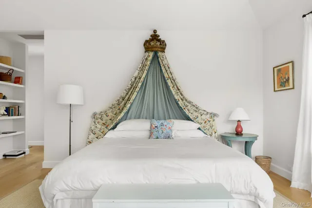 a bedroom with a bed and a chandelier