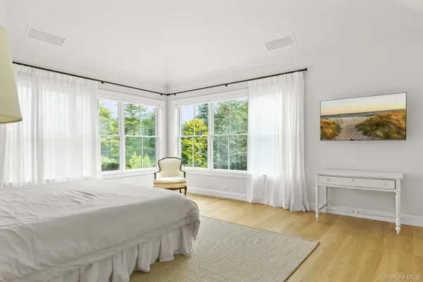 a spacious bedroom with a large bed and a large window