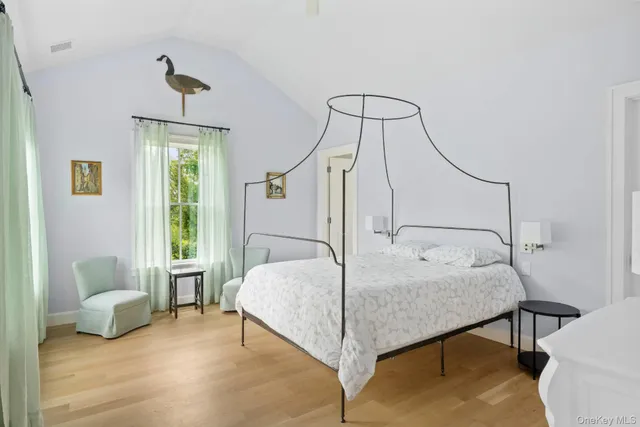 a bedroom with a bed window and a potted plant
