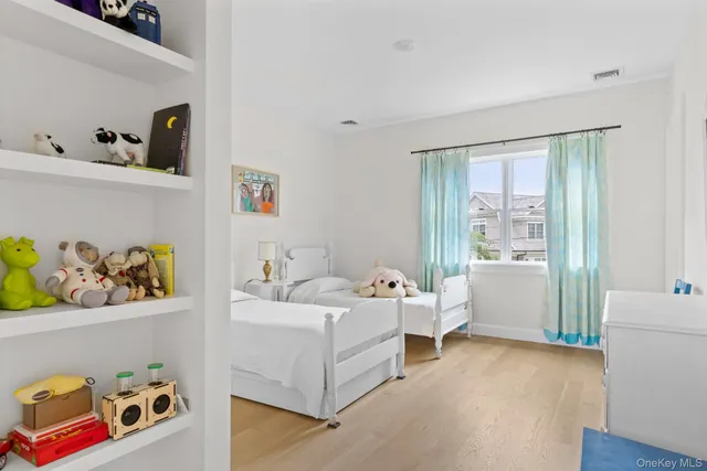 a room with a bed and wooden floor