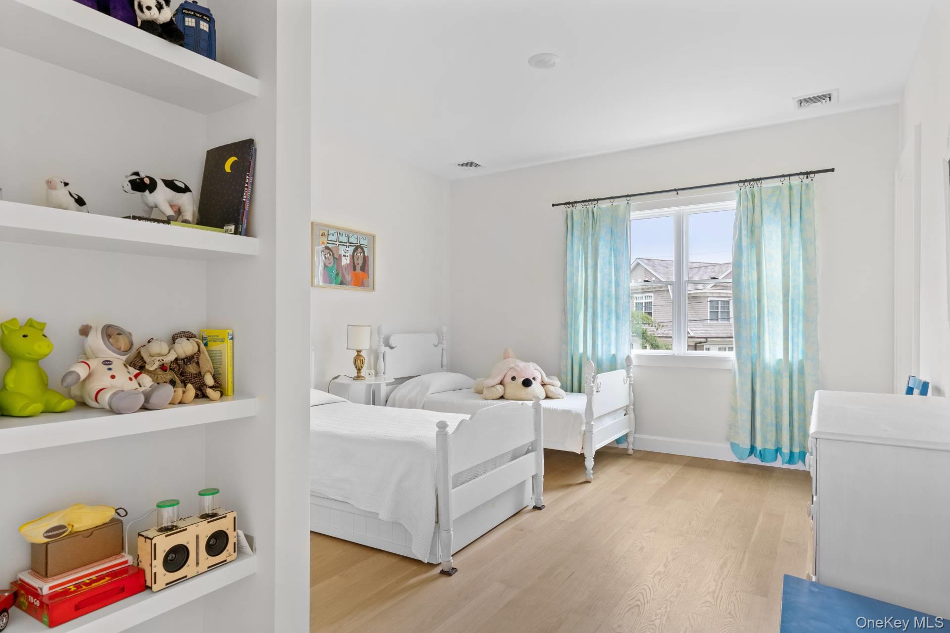 26 Georgian Lane Water Mill, NY 11976 - Photo 24 of 45 a room with a bed and wooden floor