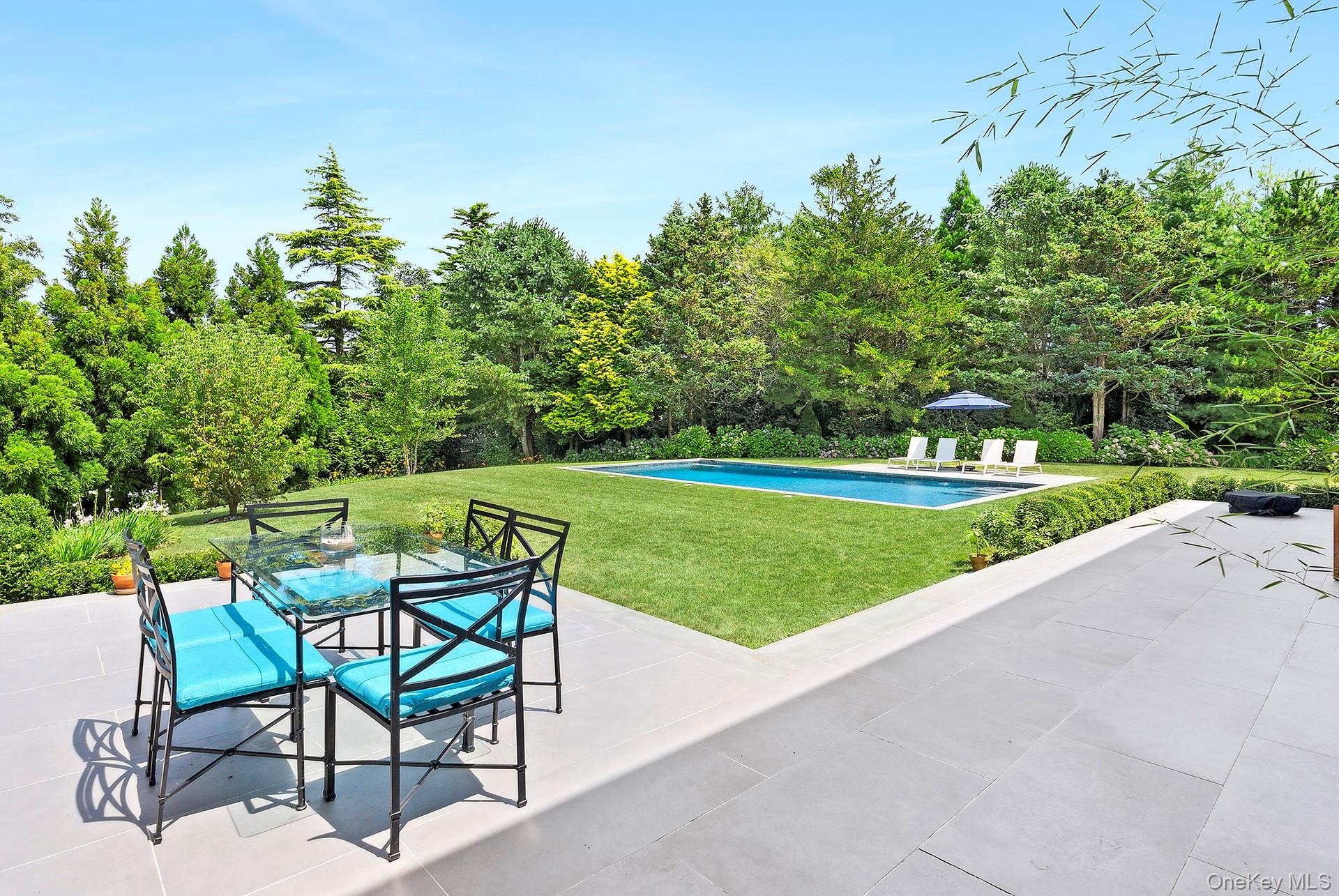 26 Georgian Lane Water Mill, NY 11976 - Photo 29 of 45 a view of a chairs and table in the garden