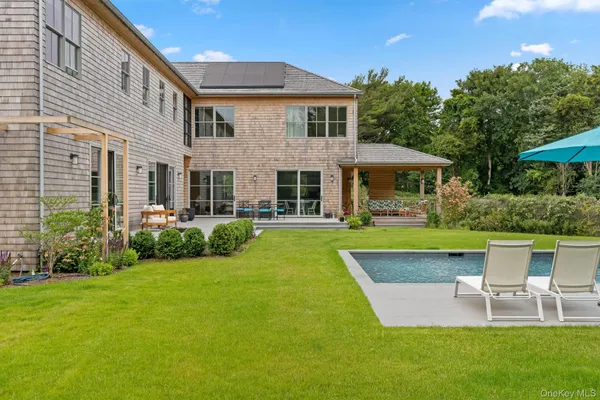 a view of a house with a yard porch and sitting area