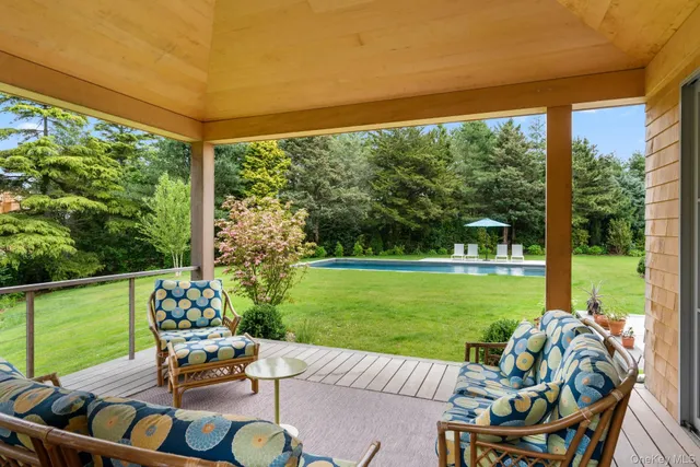 a view of a patio with a table chairs and a backyard