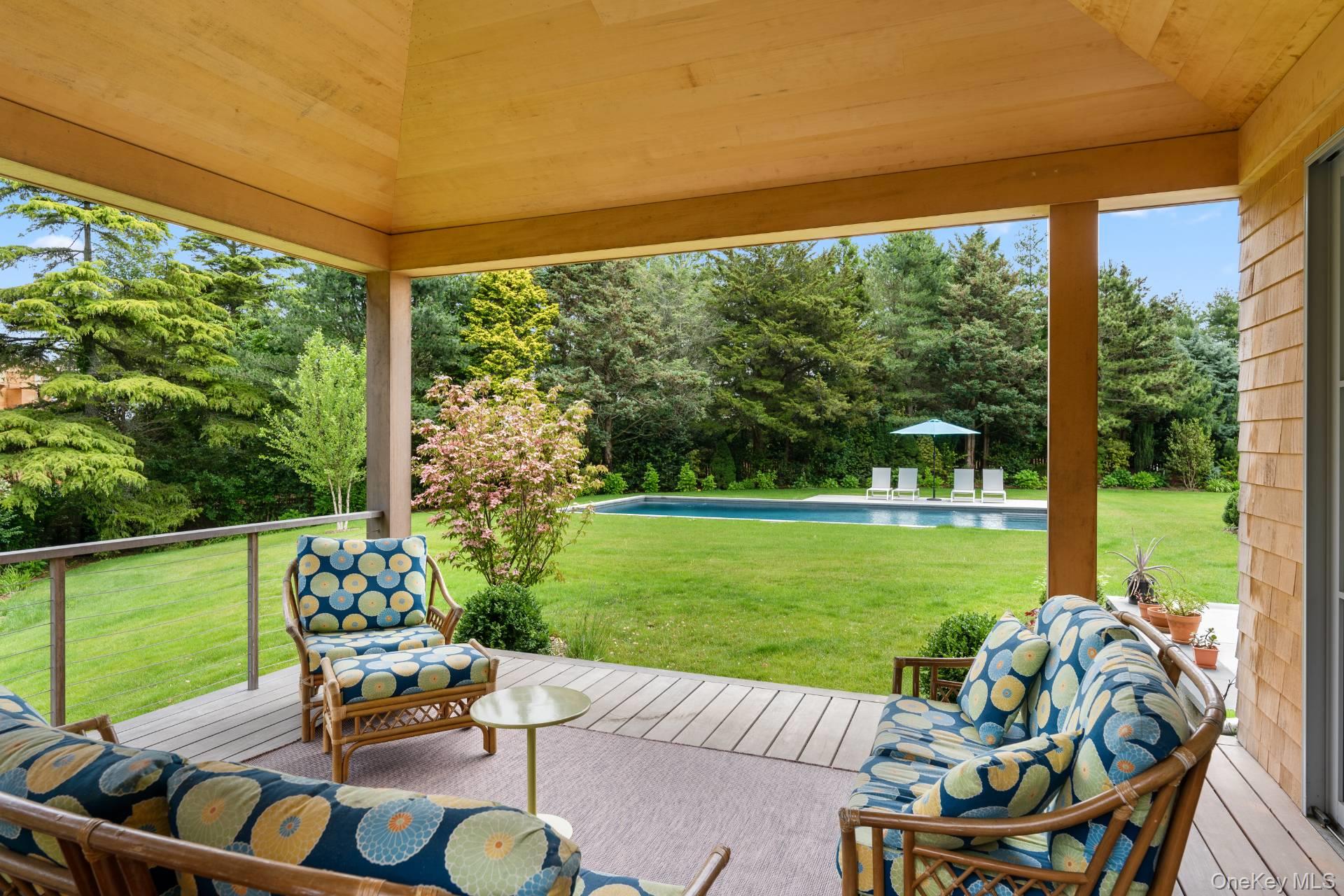 26 Georgian Lane Water Mill, NY 11976 - Photo 40 of 45 a view of a patio with a table chairs and a backyard