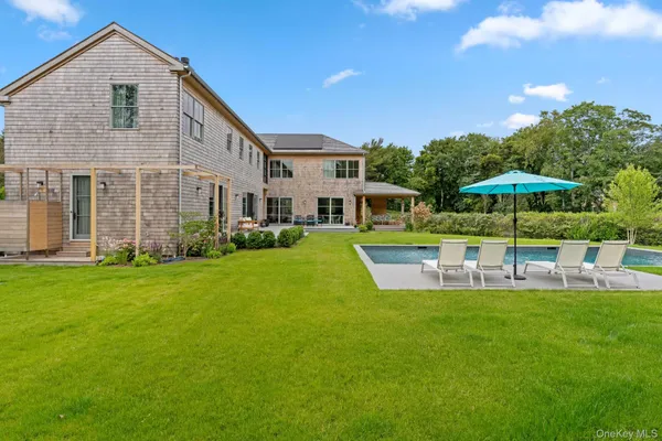 a view of a house with a yard porch and sitting area