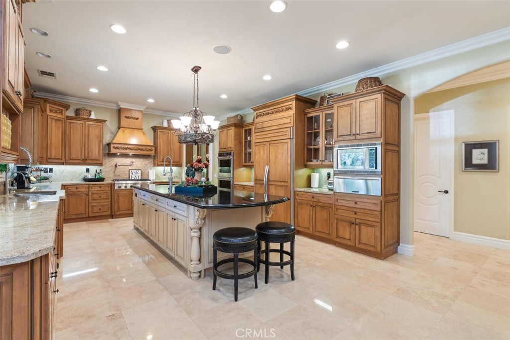 23965 Lawson Road Corona, CA 92883 - Photo 15 of 74 a kitchen with kitchen island granite countertop lots of counter top space