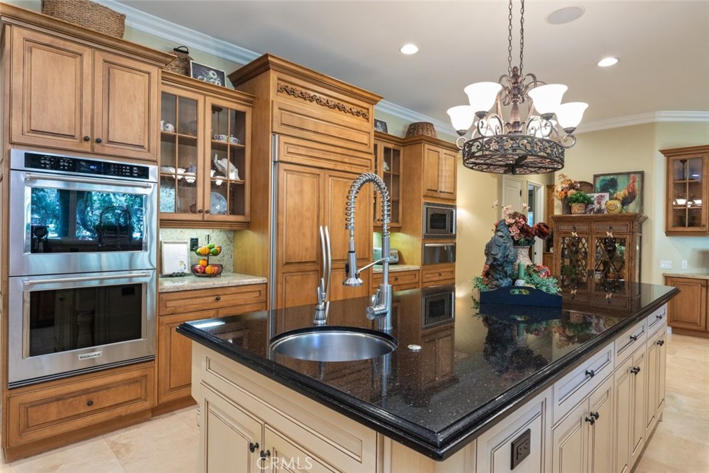 23965 Lawson Road Corona, CA 92883 - Photo 17 of 74 a kitchen with stainless steel appliances granite countertop a sink a stove and a microwave