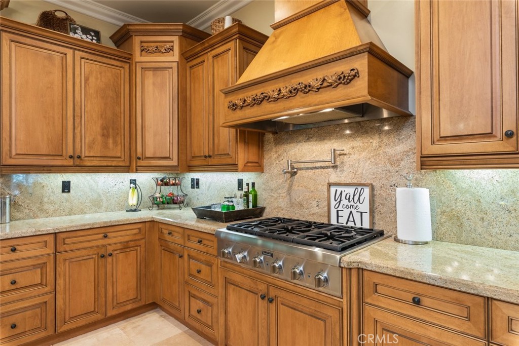 23965 Lawson Road Corona, CA 92883 - Photo 19 of 74 a kitchen with stainless steel appliances granite countertop a sink a stove and cabinets