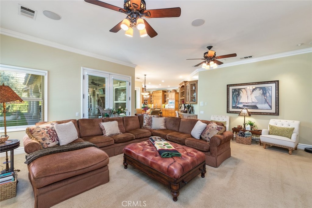 23965 Lawson Road Corona, CA 92883 - Photo 23 of 74 a living room with furniture a ceiling fan and a window