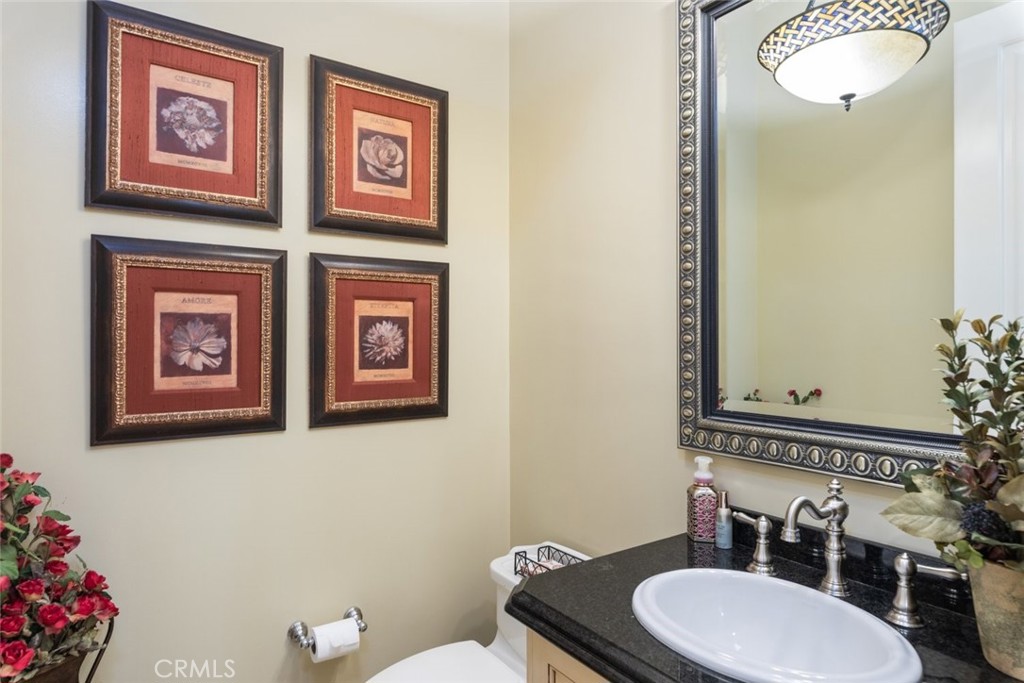 23965 Lawson Road Corona, CA 92883 - Photo 25 of 74 a bathroom with a toilet sink and mirror