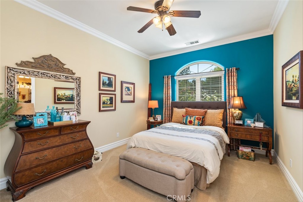 23965 Lawson Road Corona, CA 92883 - Photo 26 of 74 a bedroom with a bed and a chandelier