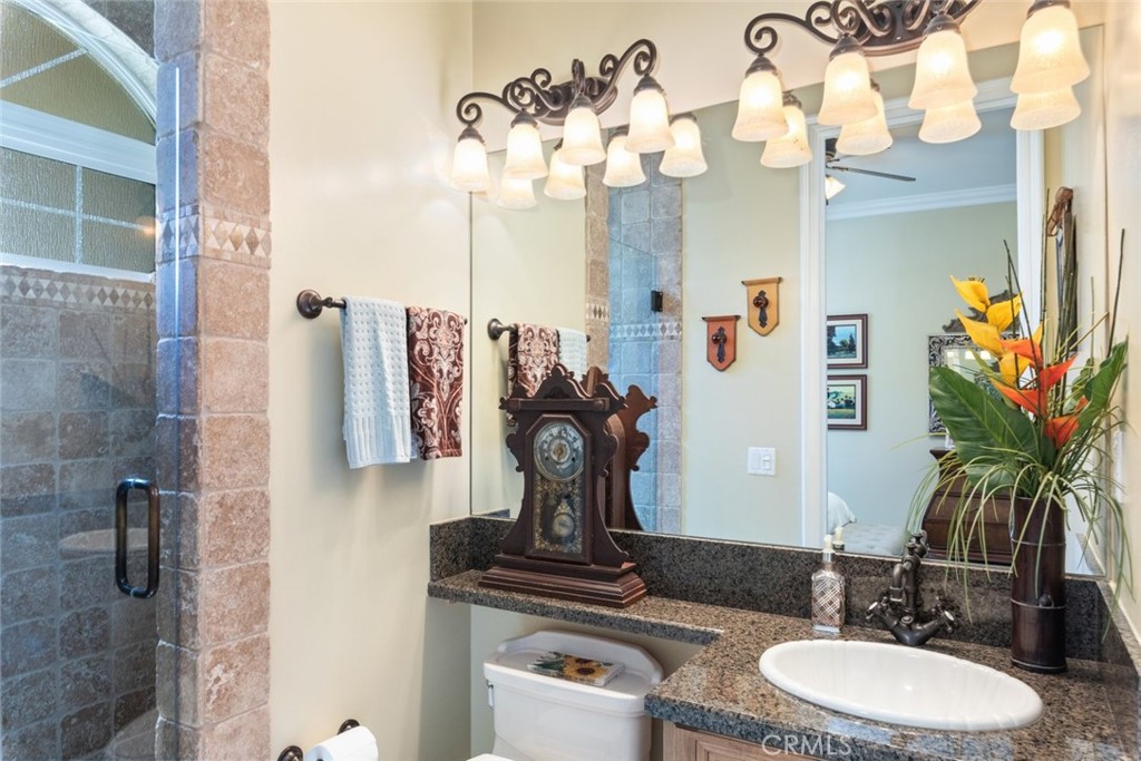 23965 Lawson Road Corona, CA 92883 - Photo 27 of 74 a bathroom with a sink a mirror and a shower