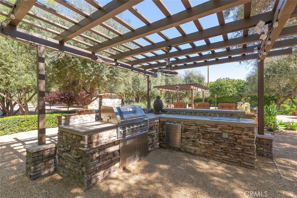 23965 Lawson Road Corona, CA 92883 - Photo 46 of 74 a view of a patio with table and chairs and couches with wooden fence
