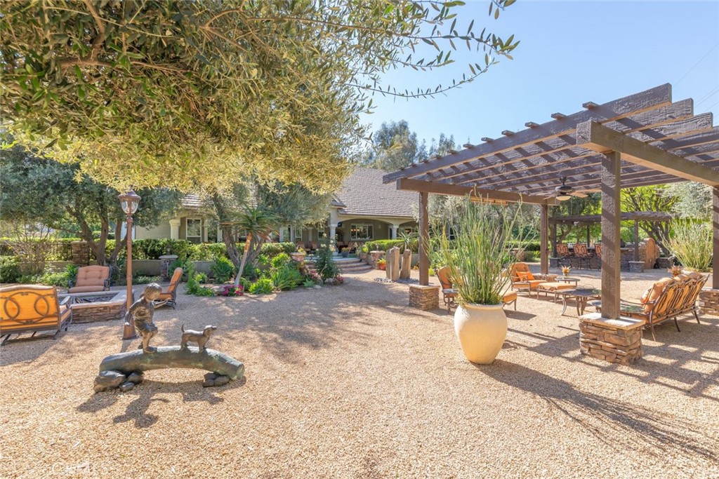 23965 Lawson Road Corona, CA 92883 - Photo 49 of 74 a view of a patio with a table and chairs and potted plants
