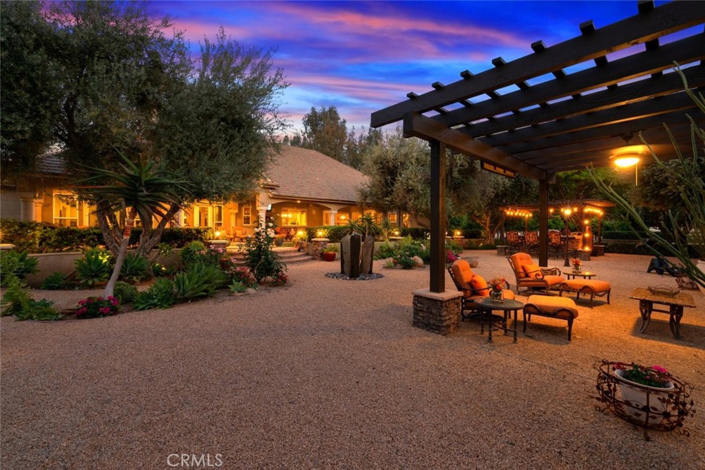23965 Lawson Road Corona, CA 92883 - Photo 5 of 74 a view of a patio with a table and chairs under an umbrella with a patio