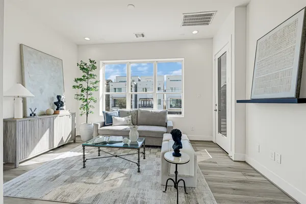 a kitchen with stainless steel appliances granite countertop a dining table chairs refrigerator sink and cabinets