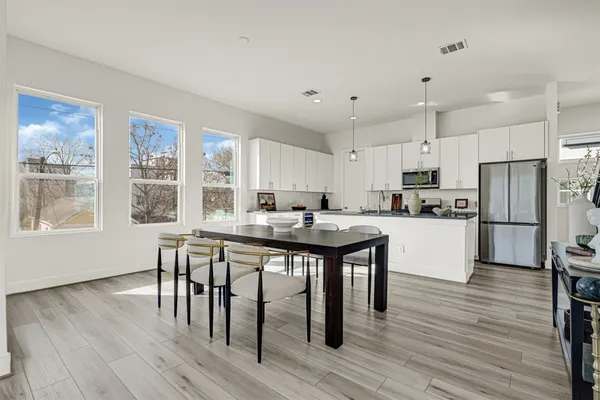 a living room with lots of furniture and kitchen view