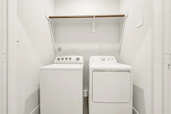 a spacious bedroom with a bed and wooden floor