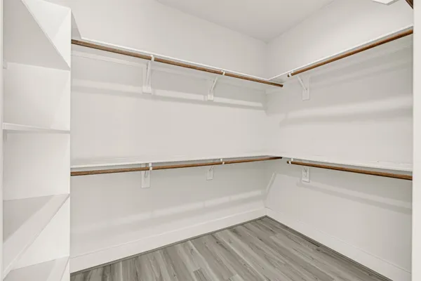 a bathroom with a double vanity sink a mirror and a bathtub