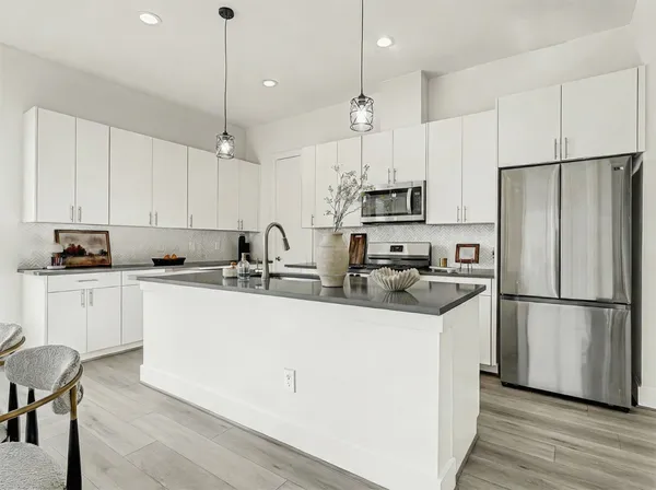a kitchen with sink cabinets and wooden floor