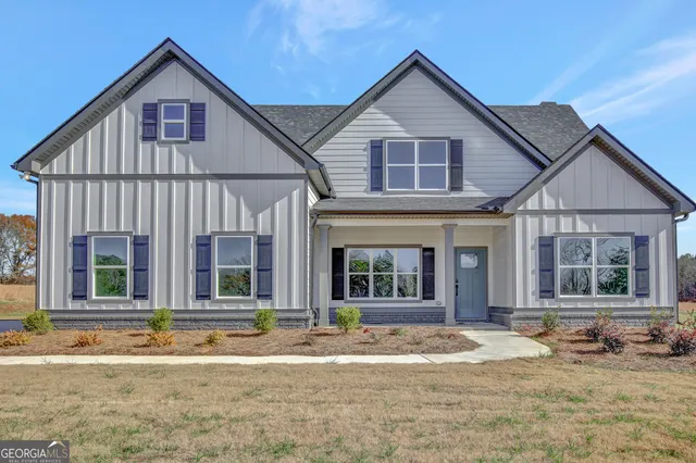 a view of a house with a yard and plants