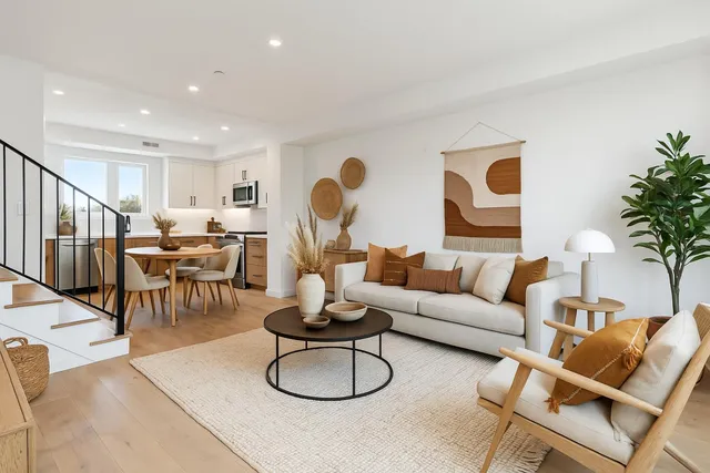 a living room with furniture and flowers