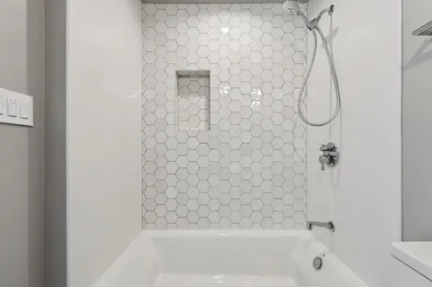 a bathroom with a bath tub and a shower