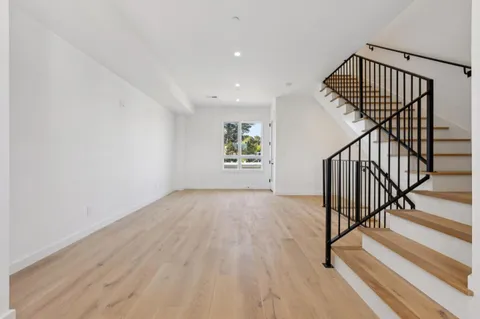 a view of an entryway with wooden floor