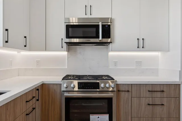 a kitchen with a stove and a microwave