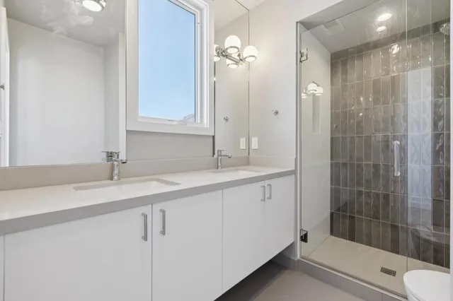 a bathroom with a shower sink and mirror