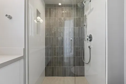 a bathroom with a glass shower door
