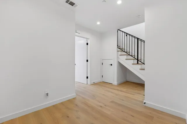 a view of an empty room with stairs