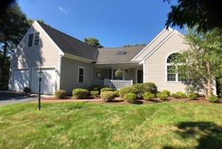 40 Amos Landing Road Mashpee, MA 02649 - Photo 1 of 28 a backyard of a house with table and chairs and potted plants