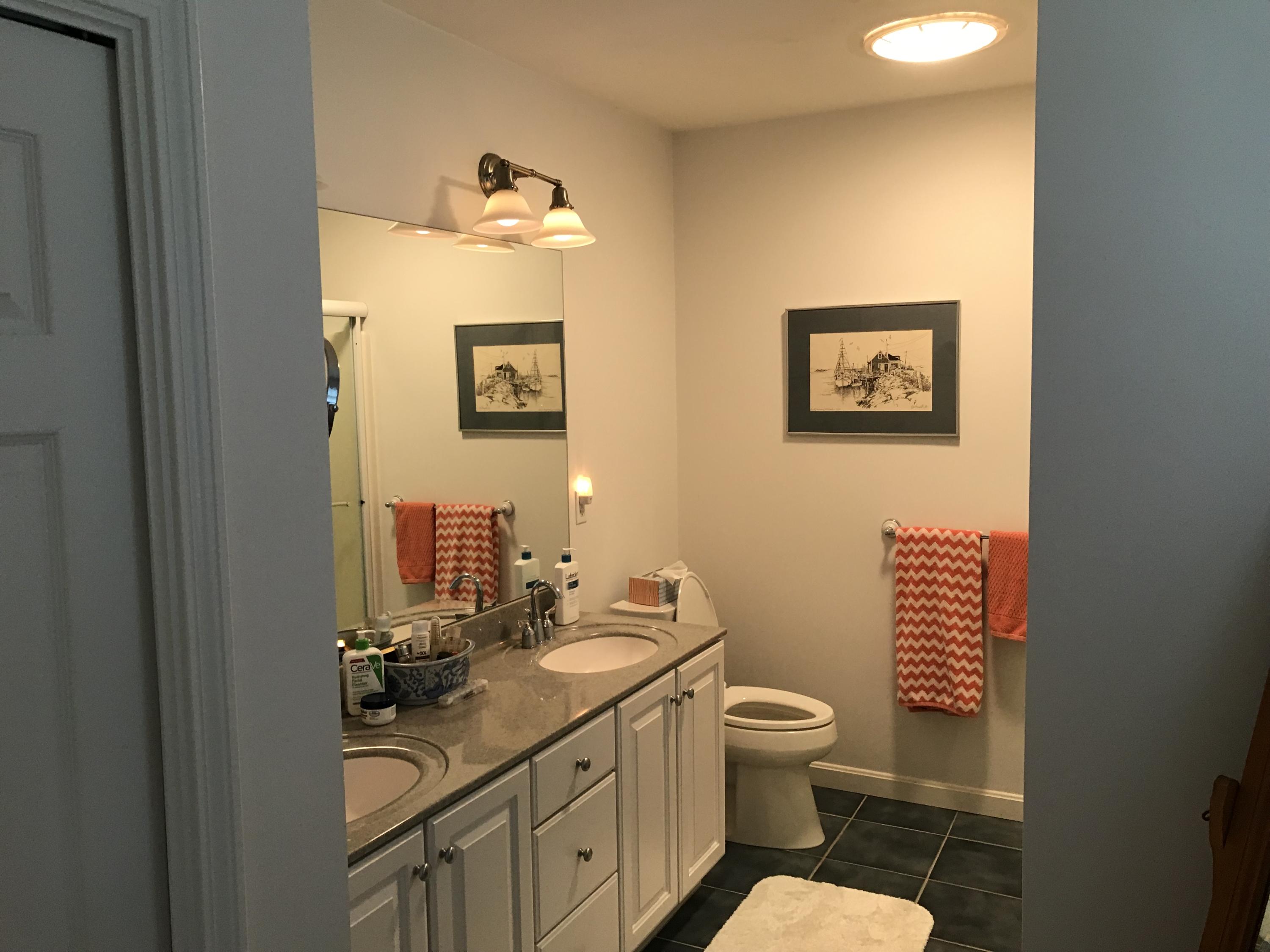 40 Amos Landing Road Mashpee, MA 02649 - Photo 14 of 28 a bathroom with a toilet a sink and mirror
