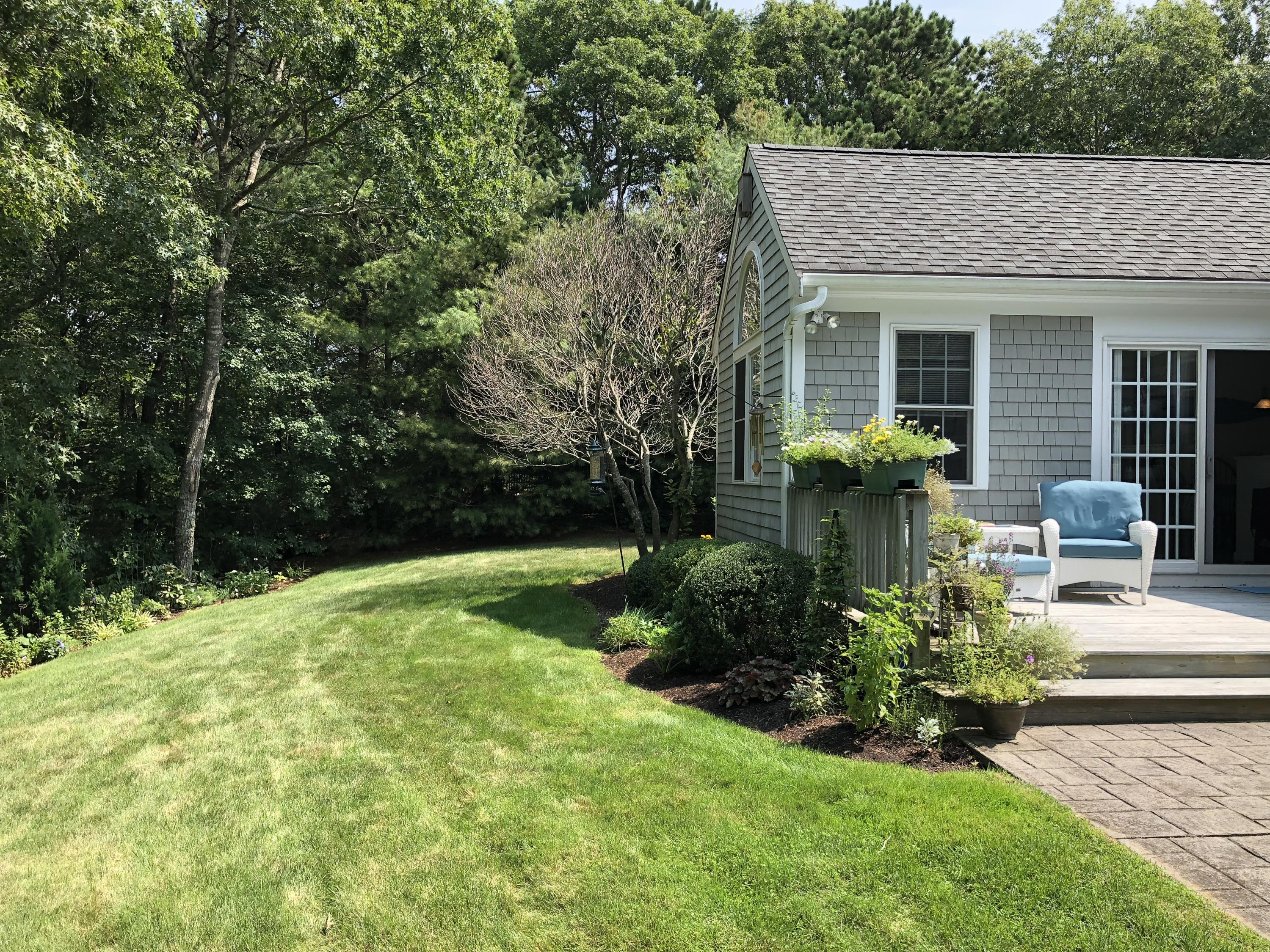 40 Amos Landing Road Mashpee, MA 02649 - Photo 28 of 28 a front view of a house with a yard table and chairs