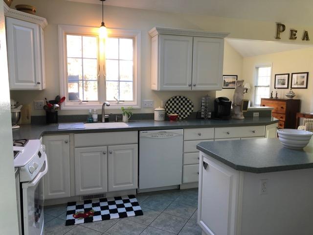 40 Amos Landing Road Mashpee, MA 02649 - Photo 8 of 28 a kitchen with granite countertop a sink a window and cabinets