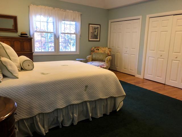 40 Amos Landing Road Mashpee, MA 02649 - Photo 10 of 28 a bedroom with a bed and wooden floor