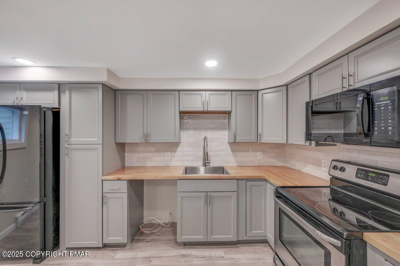 2128 Faratol Road East Stroudsburg, PA 18302 - Photo 15 of 85 a kitchen with kitchen island white cabinets and stainless steel appliances