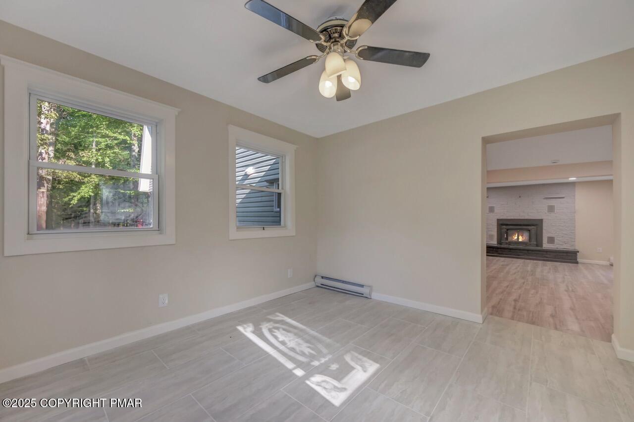 2128 Faratol Road East Stroudsburg, PA 18302 - Photo 19 of 85 a view of workspace with window ceiling fan and hardwood floor