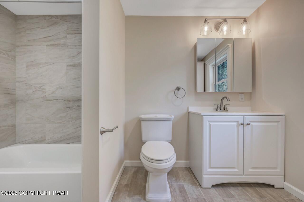 2128 Faratol Road East Stroudsburg, PA 18302 - Photo 40 of 85 a bathroom with a toilet a sink a mirror and bathtub