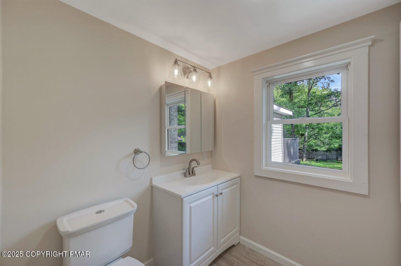 2128 Faratol Road East Stroudsburg, PA 18302 - Photo 41 of 85 a bathroom with a toilet sink and mirror