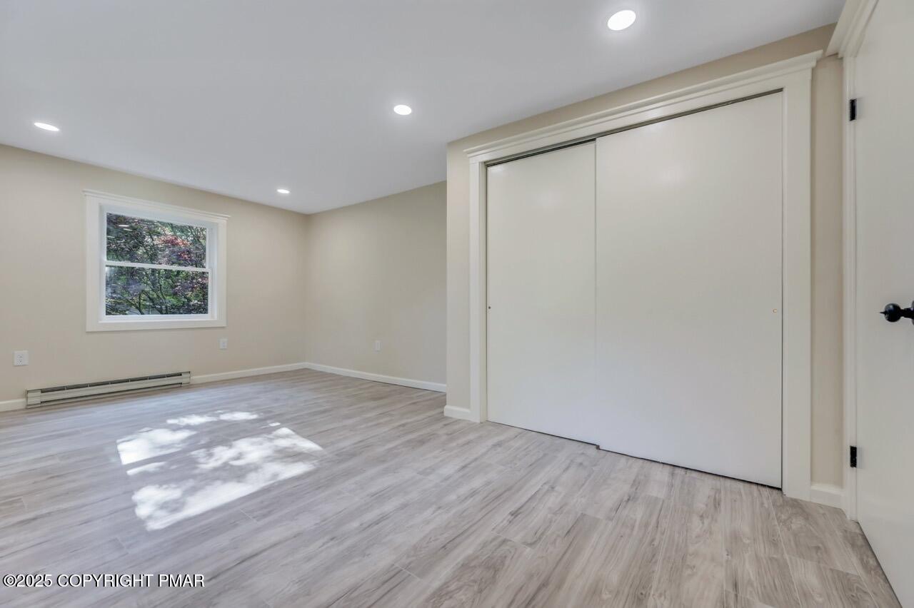 2128 Faratol Road East Stroudsburg, PA 18302 - Photo 44 of 85 an empty room with wooden floor and windows